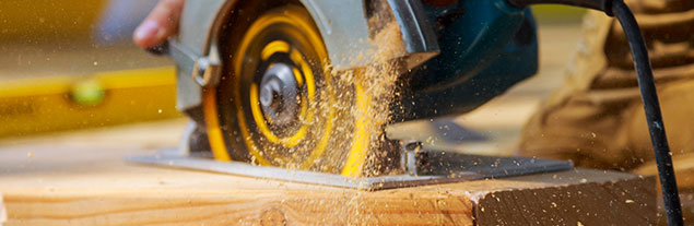 A closeup of a buzzsaw cutting through wood.